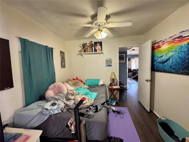 bedroom featuring ceiling fan, wood finished floors, and baseboards