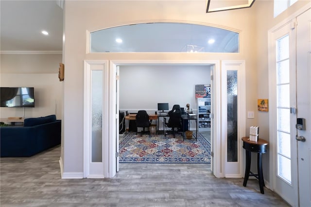 entryway featuring recessed lighting, crown molding, baseboards, and wood finished floors