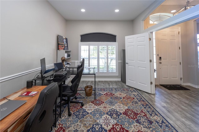 home office featuring baseboards, wood finished floors, and recessed lighting