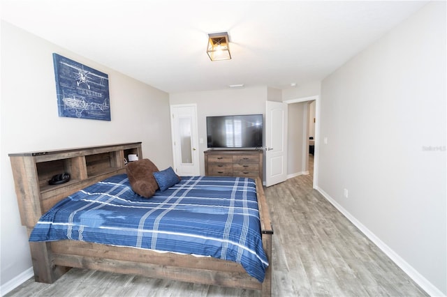 bedroom featuring baseboards and wood finished floors