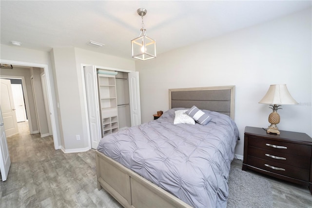 bedroom featuring a closet, baseboards, and wood finished floors