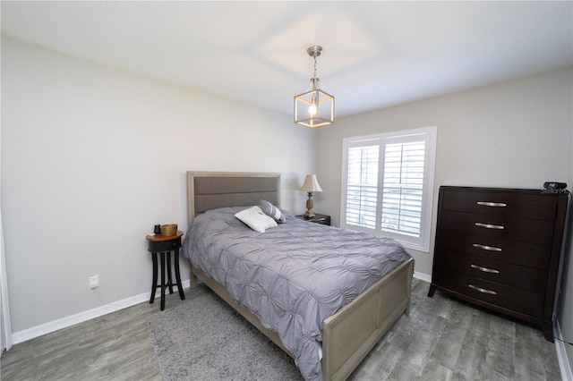 bedroom with baseboards and wood finished floors