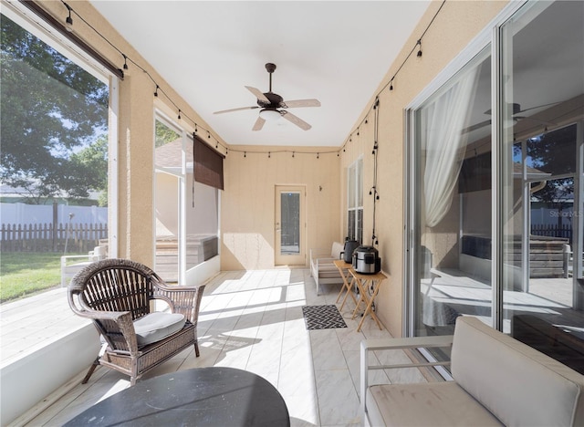 sunroom with a ceiling fan and plenty of natural light