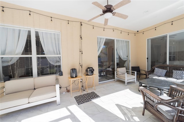 sunroom / solarium with a ceiling fan