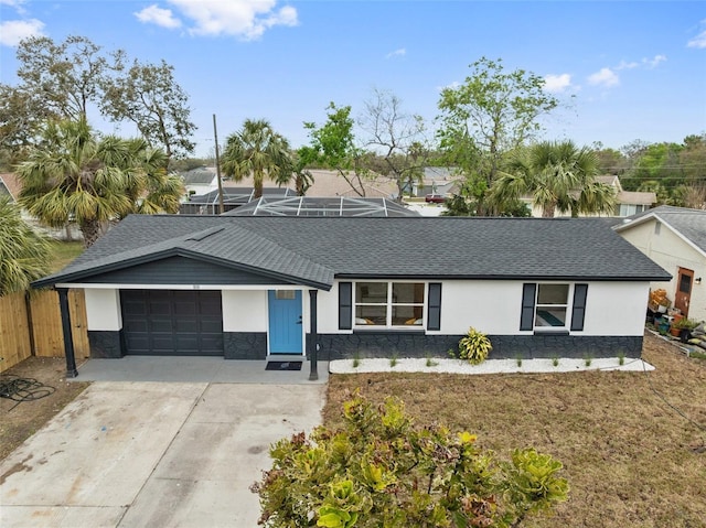 view of front of home with stucco siding, a shingled roof, an attached garage, a front yard, and driveway