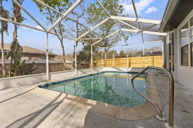 view of pool featuring a patio, a fenced backyard, glass enclosure, and a fenced in pool