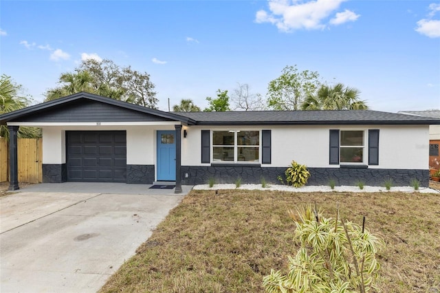 single story home with a garage, fence, driveway, stone siding, and stucco siding