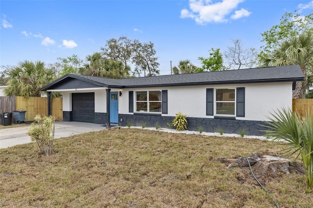 ranch-style home featuring a garage, fence, concrete driveway, and stucco siding