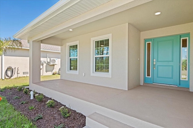 doorway to property featuring stucco siding