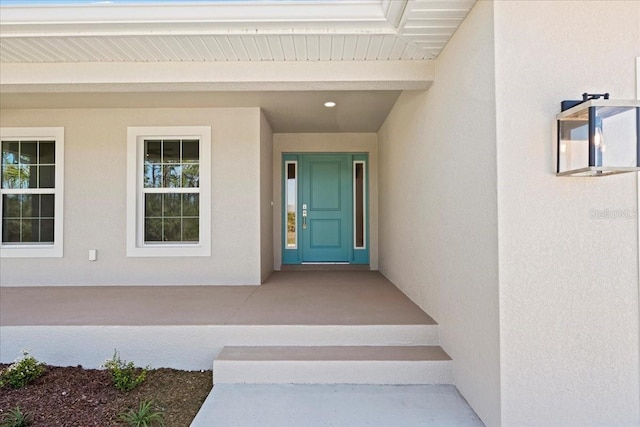 entrance to property with stucco siding