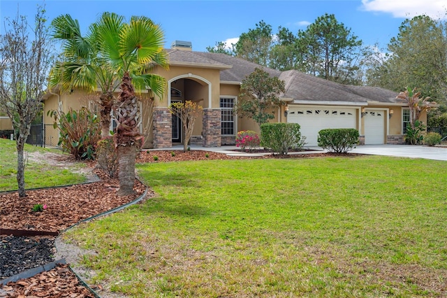 view of front of home with a garage, concrete driveway, stone siding, a front yard, and stucco siding