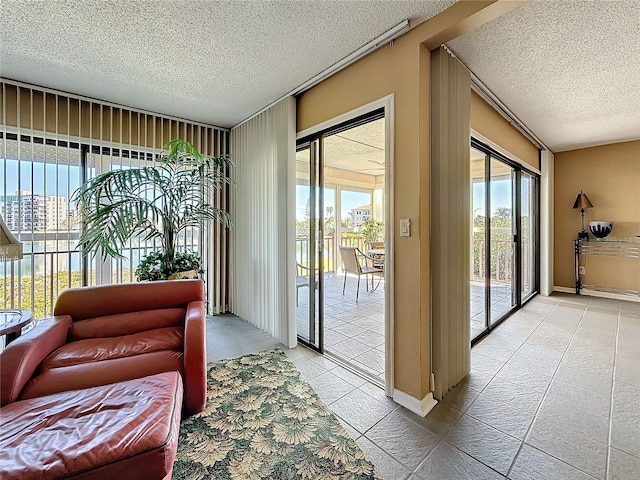 doorway with tile patterned flooring and a textured ceiling