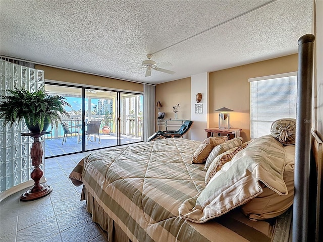 bedroom with access to exterior, tile patterned flooring, ceiling fan, and a textured ceiling