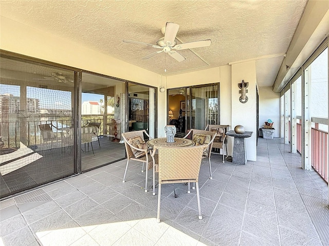 sunroom featuring plenty of natural light and ceiling fan