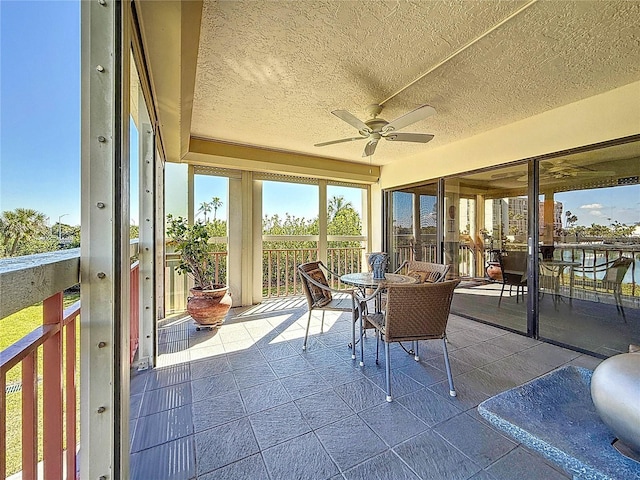 sunroom / solarium with a ceiling fan