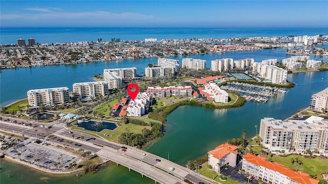 birds eye view of property with a water view and a city view