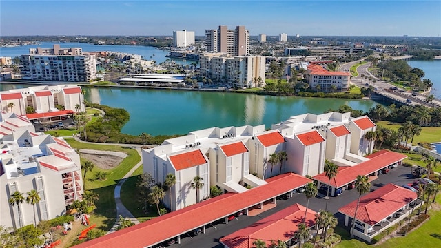 birds eye view of property with a view of city and a water view