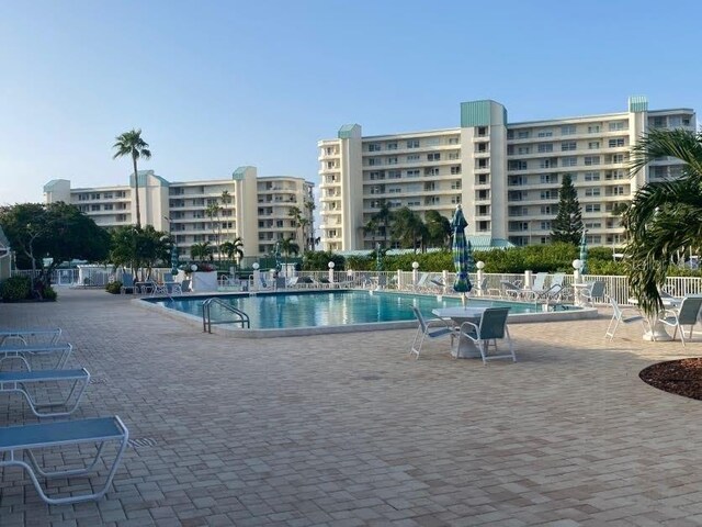 community pool with a patio area