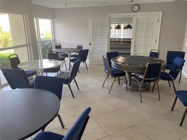 dining room with light tile patterned flooring and baseboards