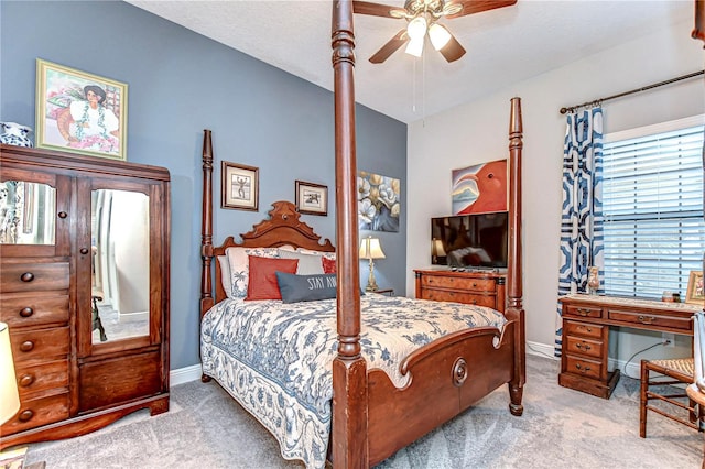 bedroom with a ceiling fan, baseboards, and carpet flooring