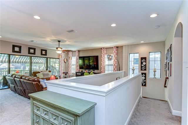 living area featuring light carpet, baseboards, visible vents, and recessed lighting