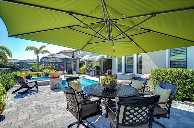 view of patio with a fenced in pool, outdoor dining area, and fence