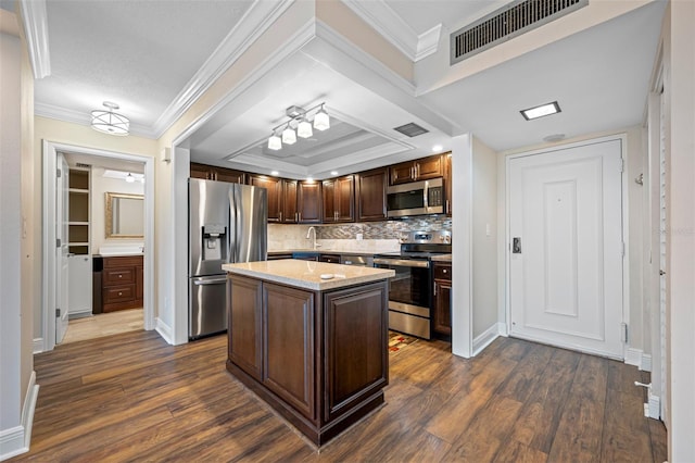 kitchen featuring a center island, dark wood finished floors, visible vents, appliances with stainless steel finishes, and dark brown cabinets