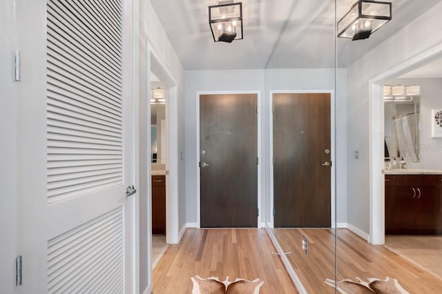 interior space featuring light wood-type flooring and baseboards