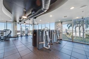 workout area with a wall of windows and plenty of natural light