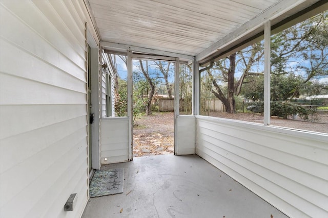 unfurnished sunroom with wood ceiling