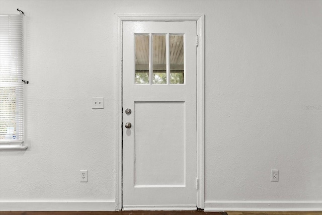 doorway to outside with baseboards