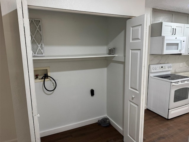 washroom featuring laundry area, dark wood-type flooring, washer hookup, and baseboards