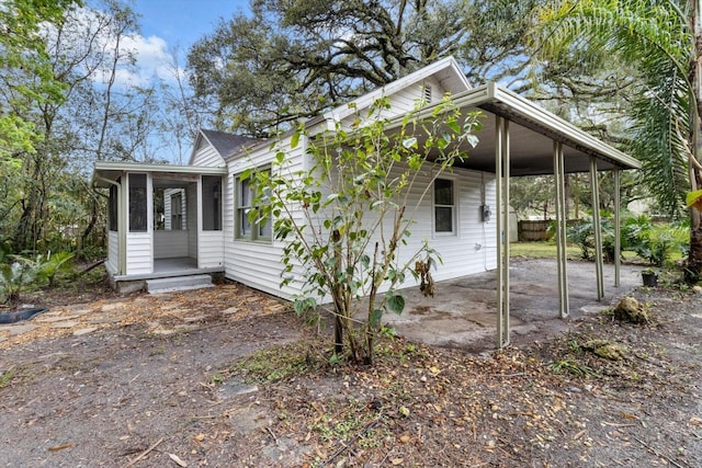 exterior space featuring a sunroom and a carport