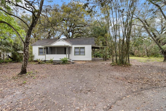 ranch-style house featuring driveway and a carport