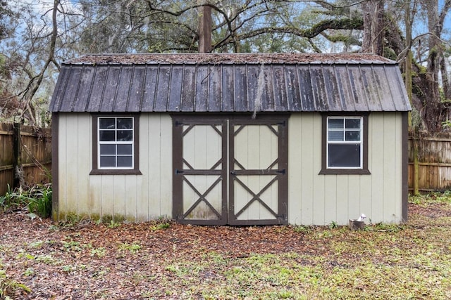 view of shed featuring fence