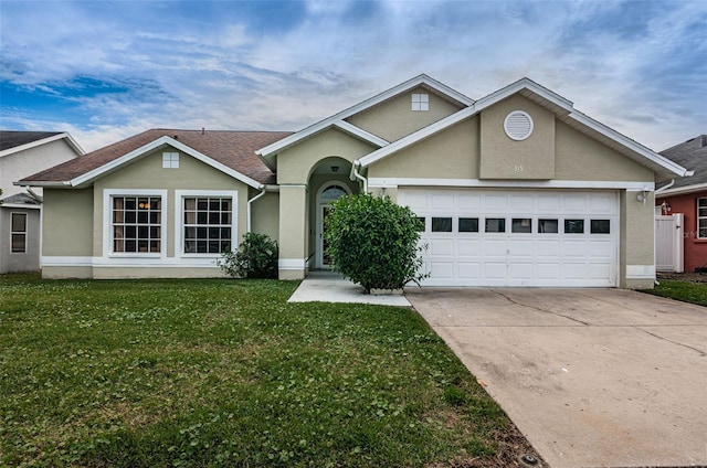 view of front facade with driveway, a garage, a front lawn, and stucco siding