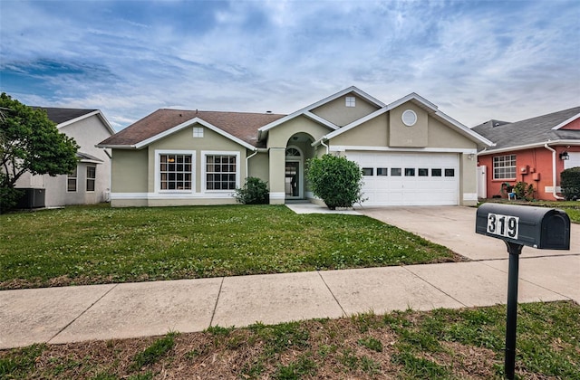 single story home featuring an attached garage, concrete driveway, a front yard, and stucco siding