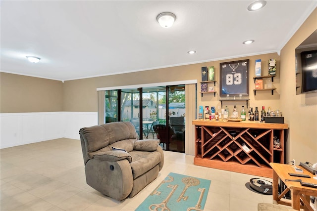 interior space featuring a wainscoted wall, a dry bar, recessed lighting, ornamental molding, and tile patterned floors