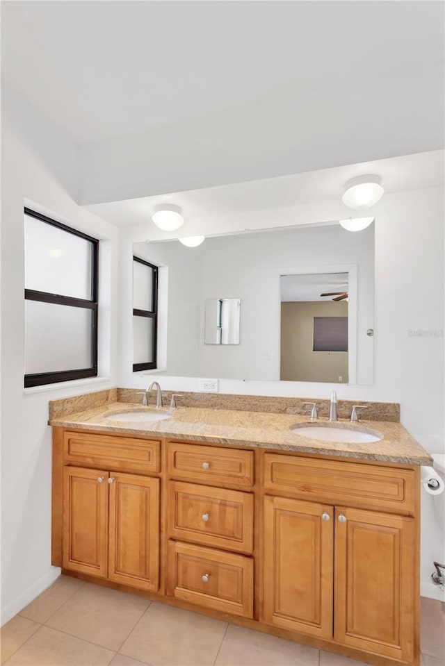 bathroom with double vanity, tile patterned flooring, and a sink