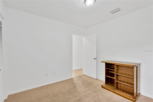 unfurnished bedroom featuring carpet, visible vents, and baseboards