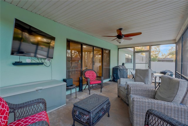 sunroom featuring a ceiling fan