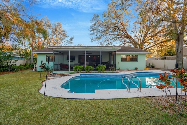 exterior space with a yard, fence, a sunroom, and a fenced in pool