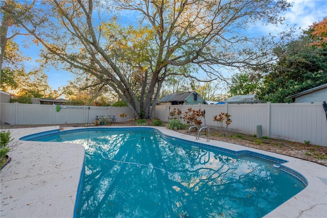 view of swimming pool featuring a fenced backyard and a fenced in pool