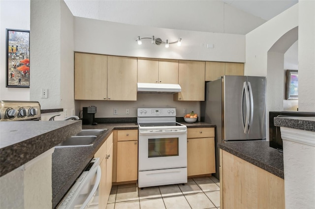 kitchen featuring white appliances, under cabinet range hood, light tile patterned floors, and light brown cabinetry