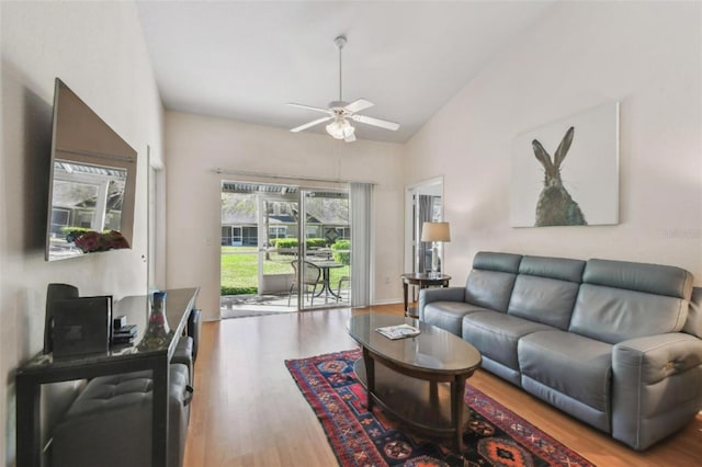 living area featuring ceiling fan, vaulted ceiling, and wood finished floors