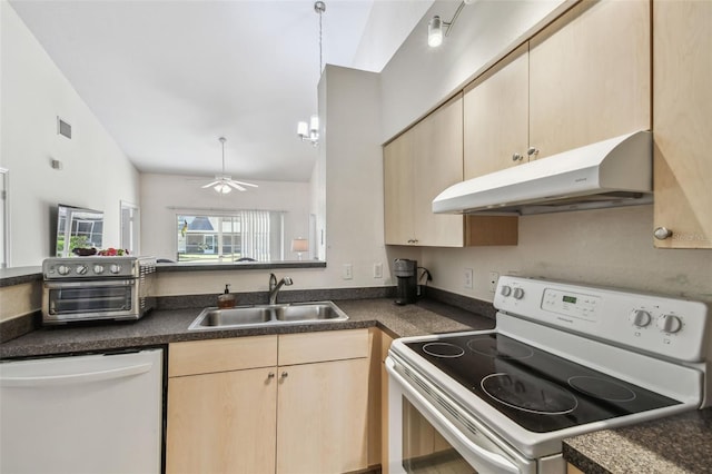 kitchen with white appliances, visible vents, light brown cabinetry, under cabinet range hood, and a sink