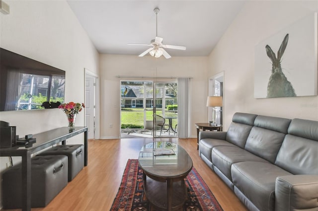 living room featuring ceiling fan, wood finished floors, and baseboards