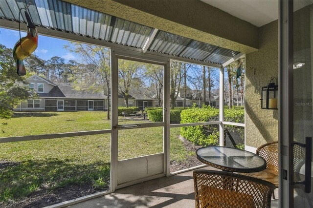 sunroom featuring a residential view