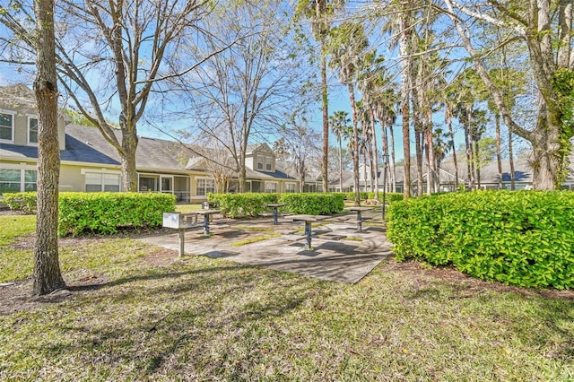 view of home's community with a yard