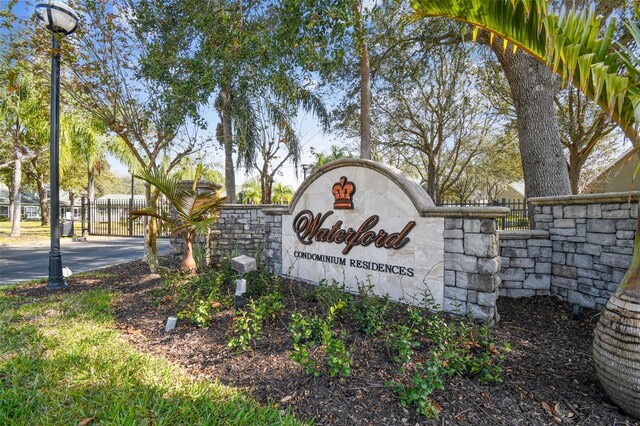 community / neighborhood sign featuring fence